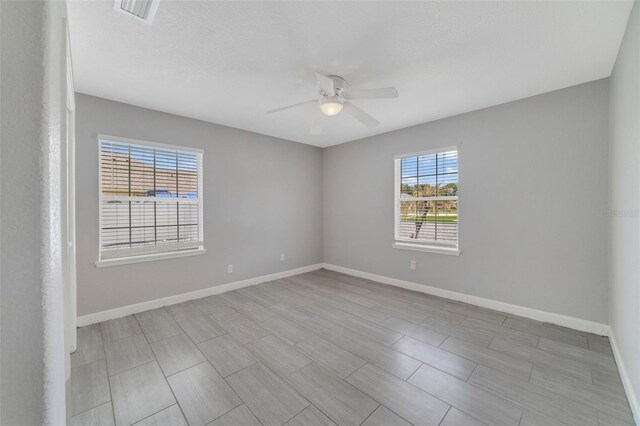 empty room featuring ceiling fan and light wood-type flooring