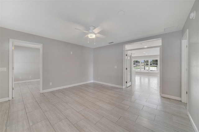 empty room featuring ceiling fan and light hardwood / wood-style floors