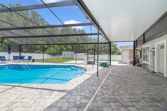 view of pool featuring a lanai, a storage unit, and a patio area