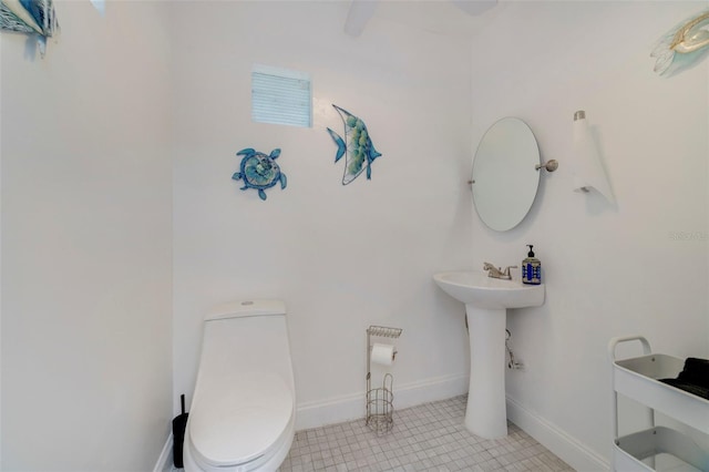 bathroom with tile patterned flooring and toilet