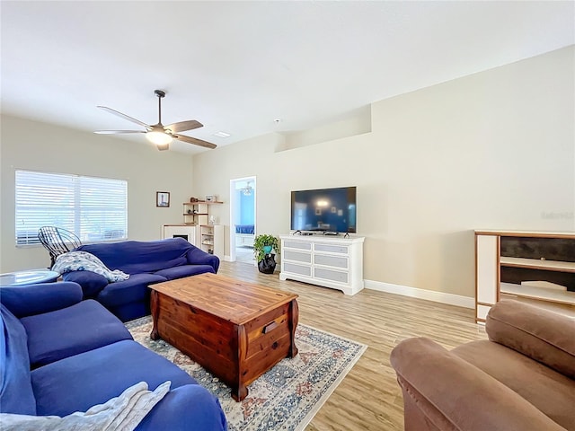 living room with ceiling fan and light hardwood / wood-style floors