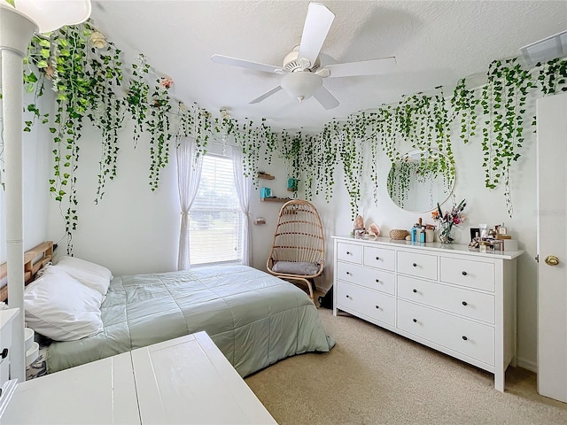 bedroom with light carpet, a textured ceiling, and ceiling fan