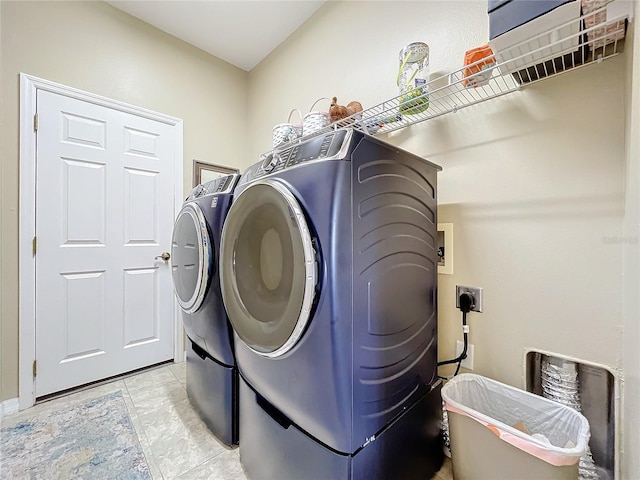 washroom featuring independent washer and dryer and light tile patterned flooring