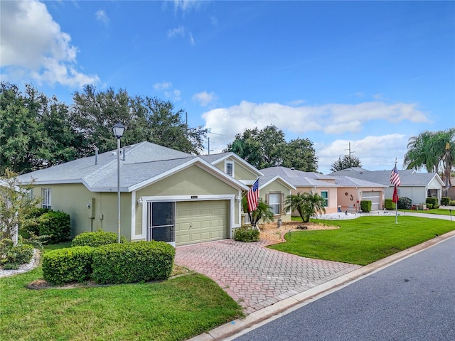 ranch-style home featuring a garage and a front yard