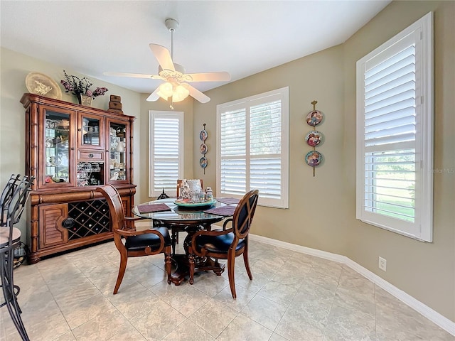 tiled dining area featuring plenty of natural light and ceiling fan