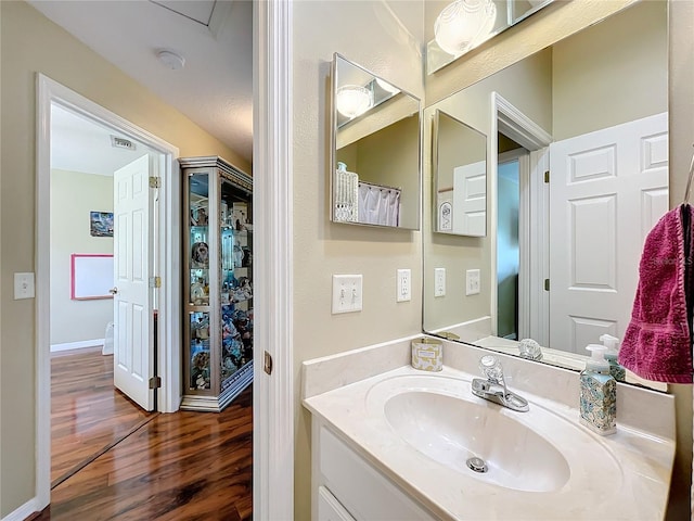 bathroom featuring hardwood / wood-style flooring and vanity