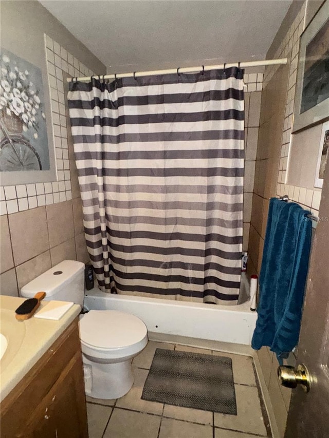 bathroom with tile patterned flooring, vanity, tile walls, and toilet