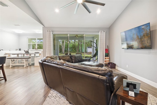 living room with light wood-type flooring, lofted ceiling, and ceiling fan