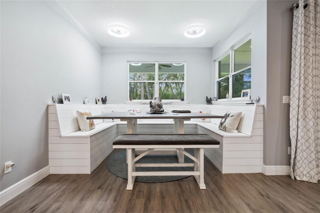 dining space featuring a textured ceiling and dark hardwood / wood-style floors