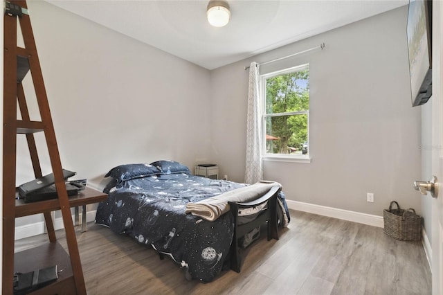 bedroom with wood-type flooring