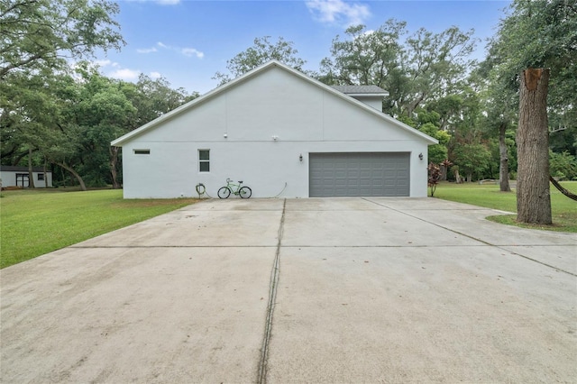 view of side of home featuring a garage and a yard