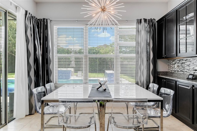 dining area featuring a chandelier and light tile patterned floors