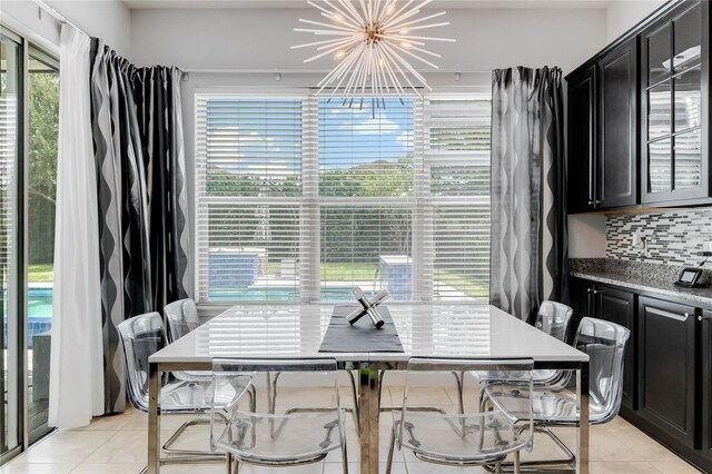 dining room featuring an inviting chandelier and light tile patterned floors