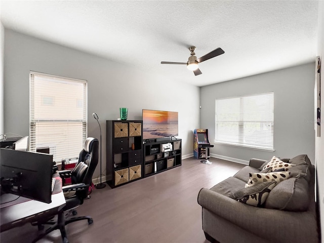 home office featuring ceiling fan, hardwood / wood-style floors, and a textured ceiling