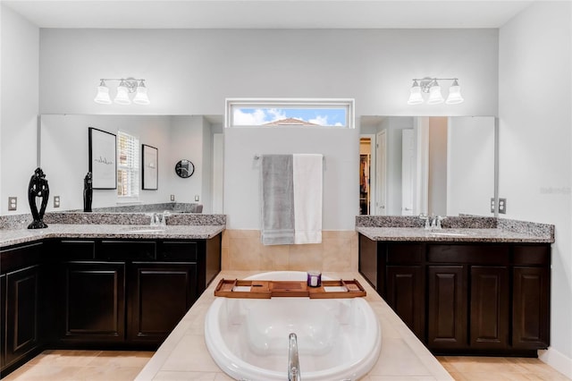 bathroom with vanity and tiled tub