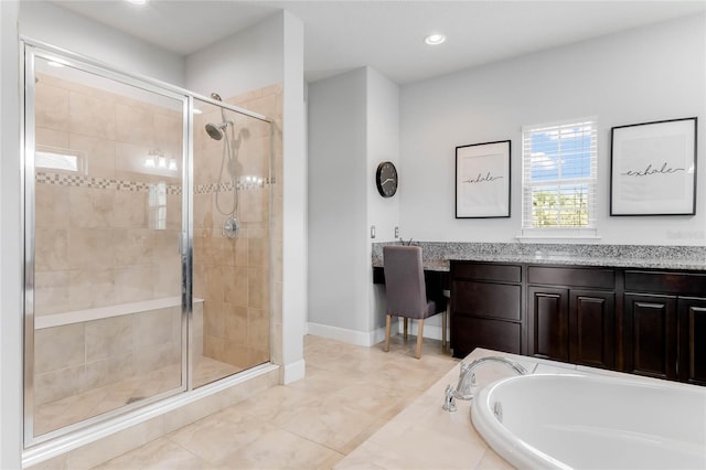 bathroom with vanity and separate shower and tub