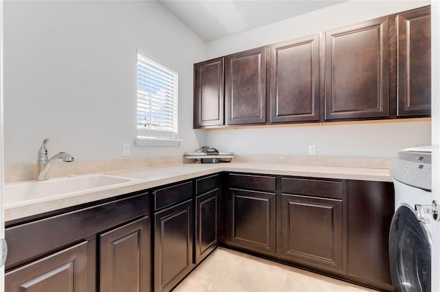 clothes washing area with cabinets, washer / dryer, sink, and light tile patterned floors