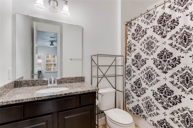 bathroom featuring vanity, a shower with shower curtain, ceiling fan, and toilet