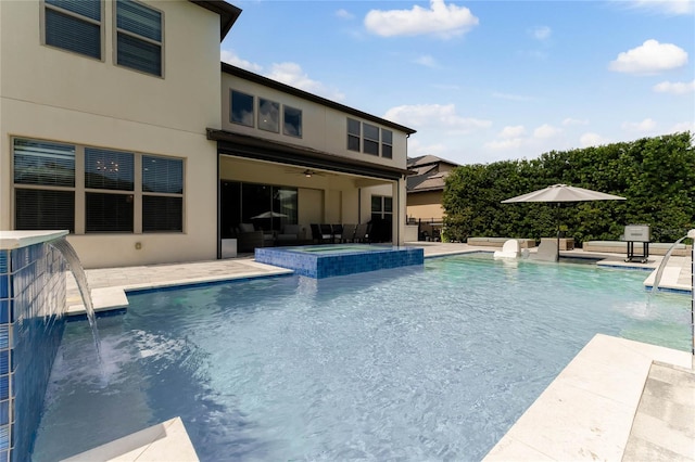 view of swimming pool featuring ceiling fan, a patio area, an in ground hot tub, and pool water feature