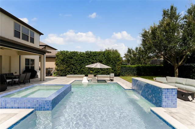 view of swimming pool featuring a patio area, an in ground hot tub, and pool water feature