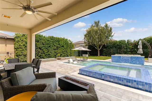 view of pool with ceiling fan, a patio, an in ground hot tub, pool water feature, and an outdoor living space