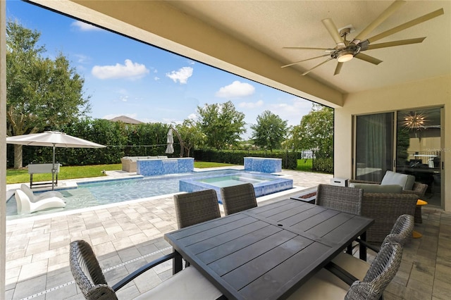 view of swimming pool featuring ceiling fan, pool water feature, an in ground hot tub, and a patio