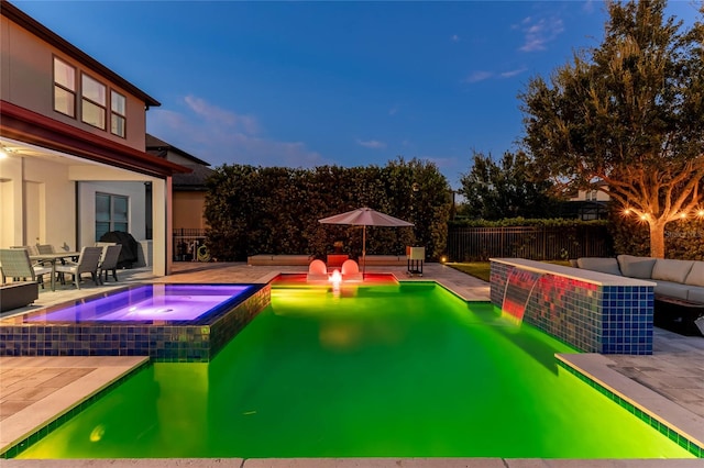 view of pool featuring an in ground hot tub and a patio area