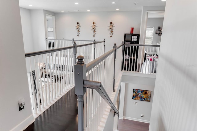 staircase with hardwood / wood-style floors