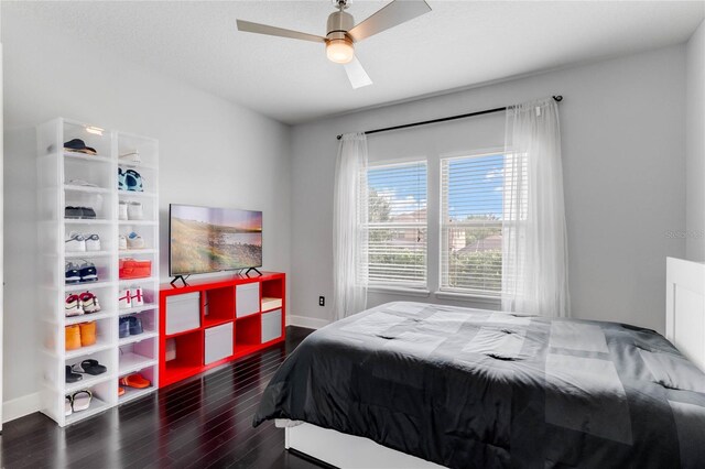 bedroom with dark hardwood / wood-style floors and ceiling fan