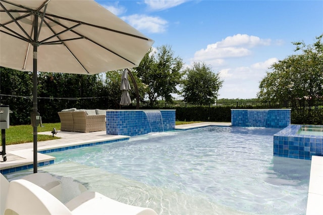 view of swimming pool with pool water feature and an outdoor hangout area