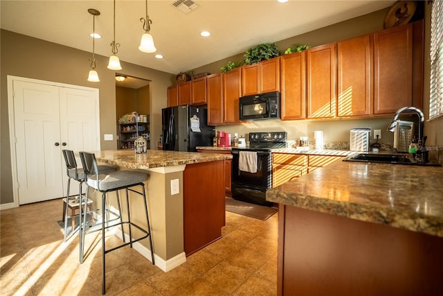 kitchen with brown cabinets, visible vents, a kitchen island, a sink, and black appliances