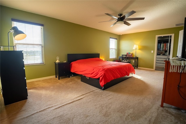 bedroom featuring carpet floors, multiple windows, ceiling fan, and baseboards