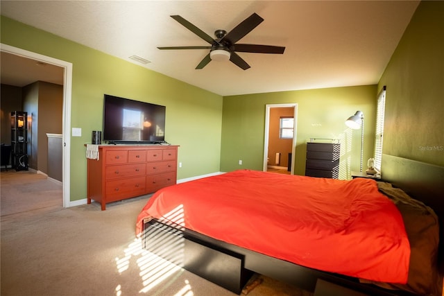 bedroom with visible vents, baseboards, ceiling fan, and light colored carpet