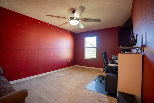 office featuring ceiling fan, a textured ceiling, baseboards, and carpet flooring