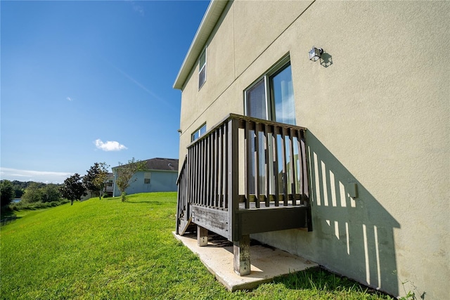 view of home's exterior with a lawn and stucco siding