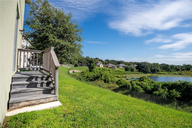 view of yard featuring a water view and fence