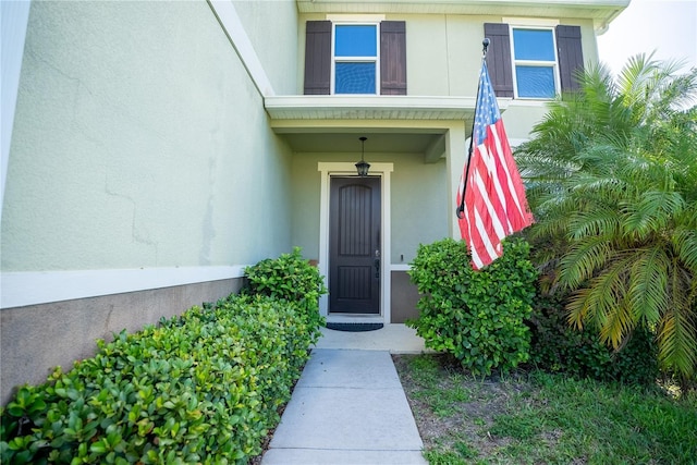 property entrance with stucco siding