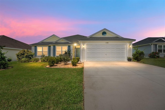 ranch-style house featuring a lawn and a garage