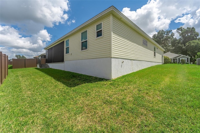 view of side of home featuring a yard