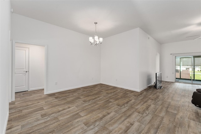 unfurnished room featuring light hardwood / wood-style flooring and an inviting chandelier