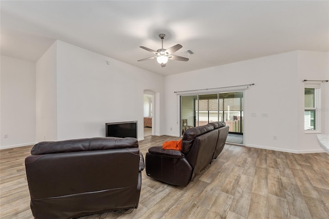 living room featuring ceiling fan and light hardwood / wood-style flooring