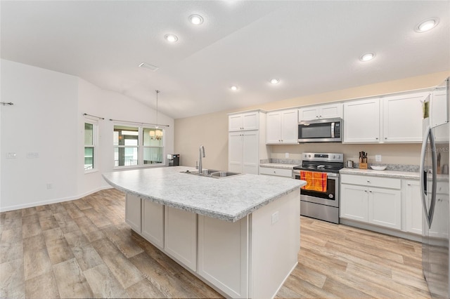 kitchen featuring white cabinets, an island with sink, stainless steel appliances, and sink