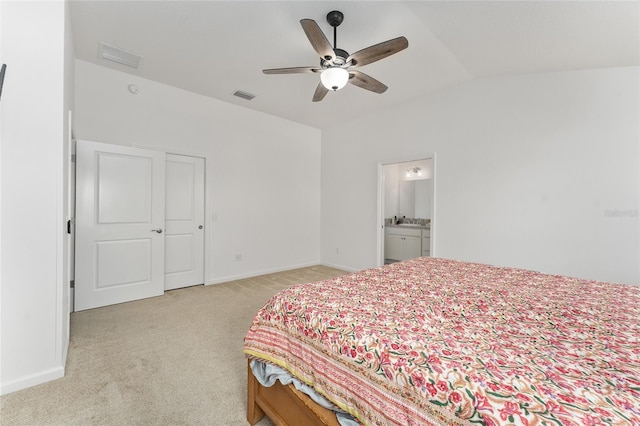 carpeted bedroom with ceiling fan, connected bathroom, and lofted ceiling