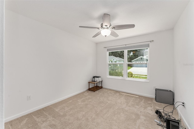 carpeted spare room with ceiling fan