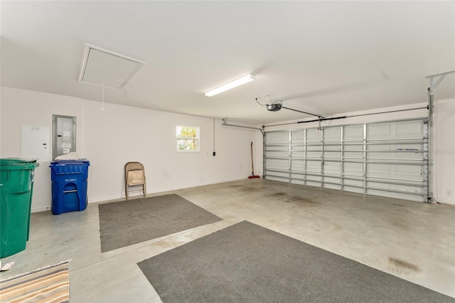 garage with a garage door opener and electric panel