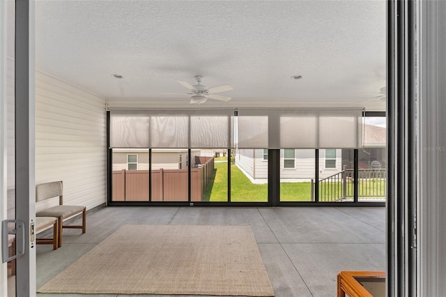 sunroom featuring ceiling fan