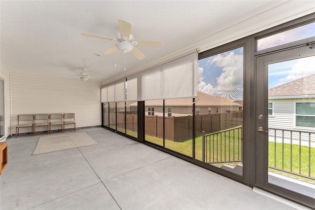 sunroom / solarium featuring ceiling fan