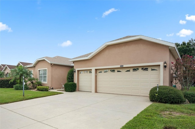 ranch-style home featuring a garage and a front lawn