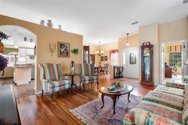 living room featuring hardwood / wood-style flooring and a notable chandelier