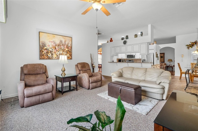 living room with ceiling fan and light colored carpet